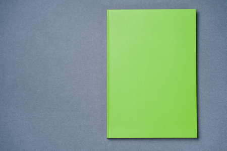 Greeen Leather notebook on paper gray background, notepad mock up, top view shot