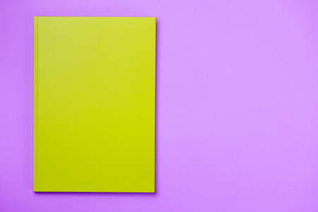 Green Leather notebook on paper pink background, notepad mock up, top view shotの写真素材