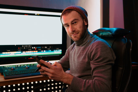 Attractive Male Video Editor Works with Footage or Video on His Personal Computer and having a break...