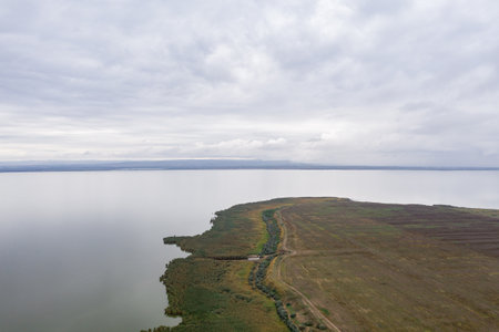 Aerial view at huge lake with a green sre and early evening skyの写真素材
