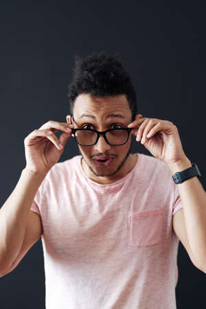 Emotional attractive male with opened mouth expresses great surprisment and frighteness, poses...