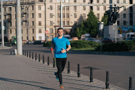 Man running in the city. Fitness workout, sport lifestyle concept.の写真素材