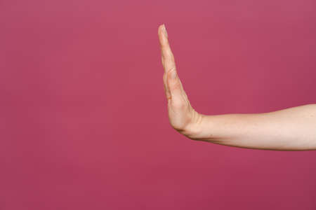 No corruption. Women hand showing stop sign on a pink background with copy space.の写真素材