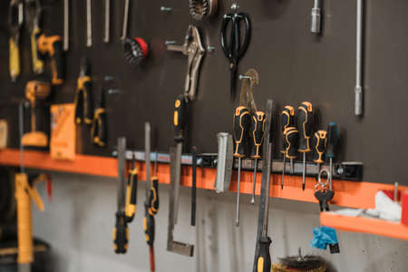 Workshop scene. Tools hanging on the wall in the workshop, garage vintage styleの写真素材