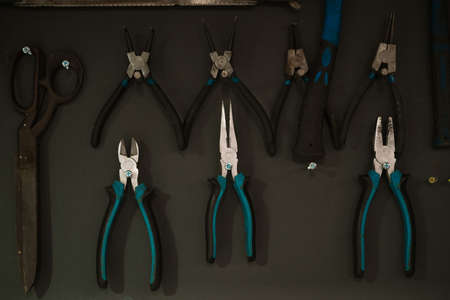Workshop scene. Tools hanging on the wall in the workshop, garage vintage style