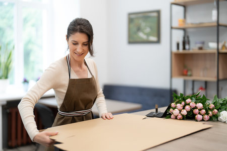 Florist working with flowers making a compositionの写真素材