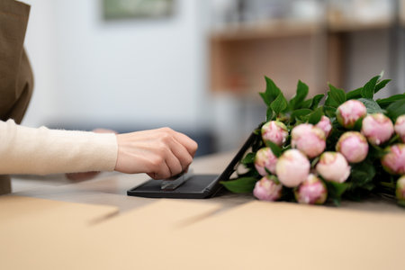 Woman hands placing a stamp on a present box while working in the shop. Prepare order for deliveryの写真素材