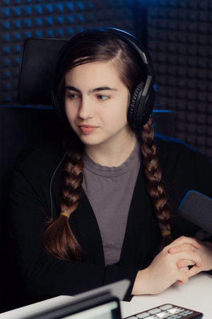 Young woman during podcast in studioの写真素材