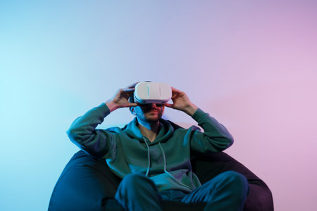 Man playing video game with virtual reality headsetの写真素材
