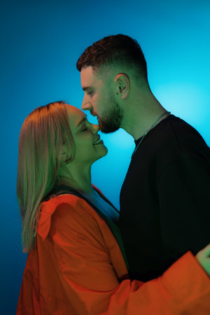 Young couple touching their noses in studioの写真素材