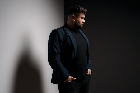 Stylish bearded man in formal outfit in studioの写真素材