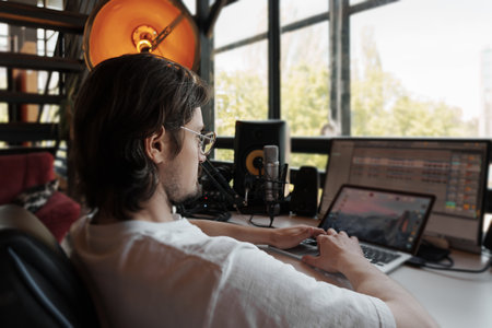 Positive musician working in recording studioの写真素材