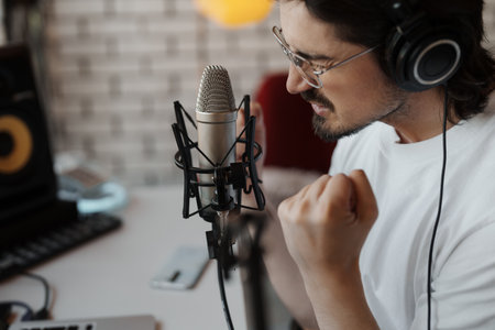Man singing in recording studioの写真素材