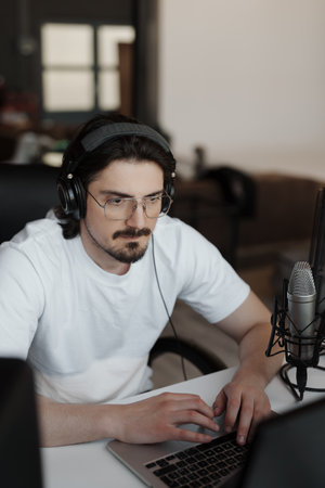 Focused man working in recording studioの写真素材