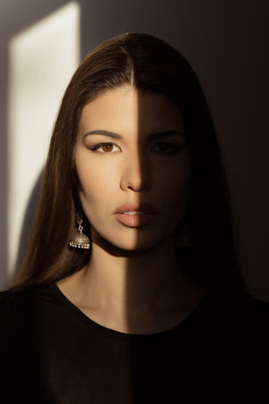 Women with half of face in darkの写真素材