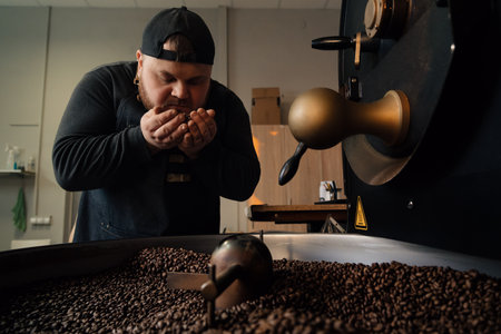 Man smelling coffee beans from cooling tray
