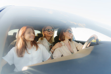 Young cheerful women driving on vacation