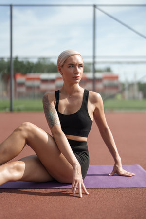 Sporty blonde woman doing yoga outdoorsの写真素材