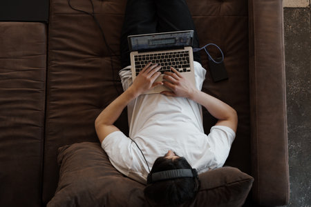 Overhead View of Man Working on Laptopの写真素材