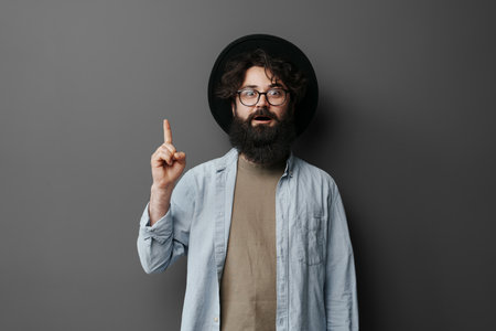 Hipster Man with Insightful Idea Pointing Upwardsの写真素材