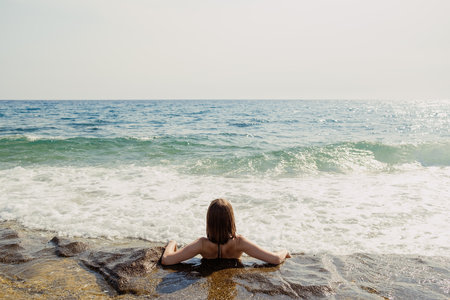 Seashore Solace: Contemplative Rest by the Oceanの写真素材