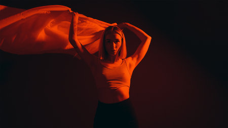 Dynamic Pose in Red Glowの写真素材