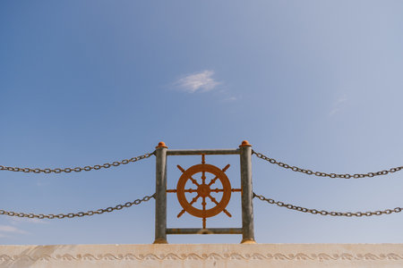 Nautical Steering Wheel Against Blue Sky