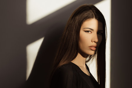 Mystery woman with dramatic lighting and shadowの写真素材