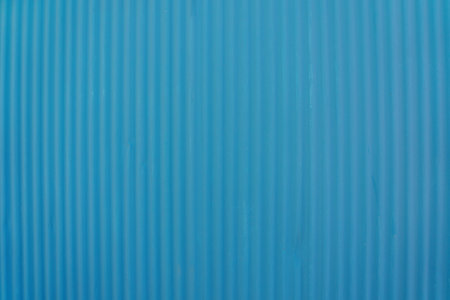 Textured blue corrugated metal wall backgroundの写真素材