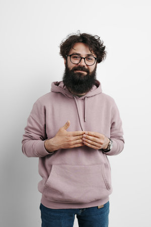 Smiling bearded man in glasses wearing a pink hoodie