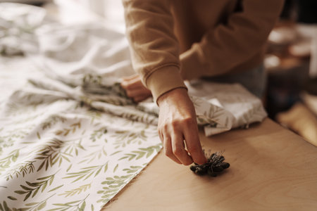 Craftswoman preparing fabric in a cozy sewing workshop