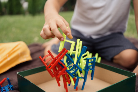 Child playing with colorful stacking toy outdoors