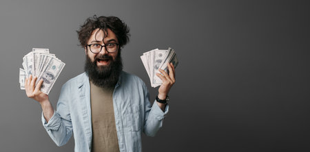 Man holding cash in hand, concept of wealth and income