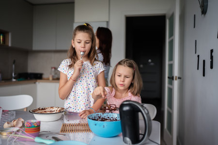Children enjoying baking together in a home kitchenの写真素材