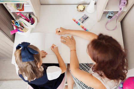 Mother Helping Daughter with Homeworkの写真素材