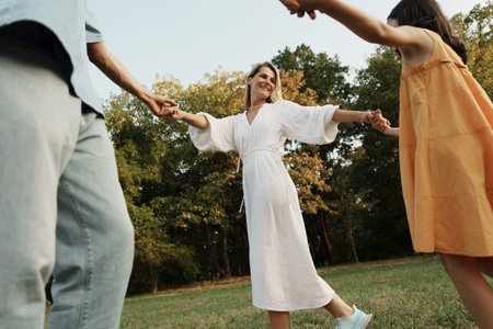 Happy family enjoying time together in a sunny parkの写真素材