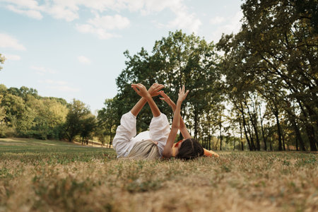 Mother and daughter enjoying a relaxing day in a sunny parkの写真素材