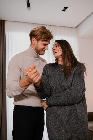 Happy couple enjoying a tender moment together at homeの写真素材