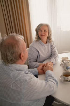 Elderly couple enjoying tea together in a cozy and peaceful setting