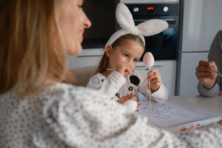 Family bonding during Easter egg painting activities at home