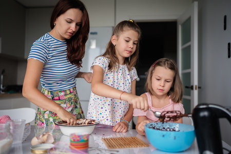 Mother and daughters baking together in the kitchen