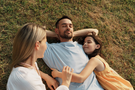 Family enjoying a relaxing day together on the green grass outdoors