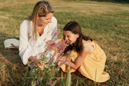 Mother and daughter enjoying a sunny day in the garden
