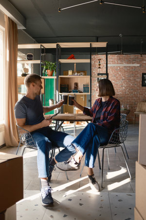 Two friends enjoying coffee and conversation in a cozy modern living room