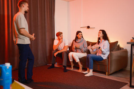 Group of friends engaging in conversation at a cozy living room gathering