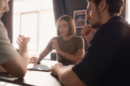 Young professionals collaborating during a meeting in a modern officeの写真素材