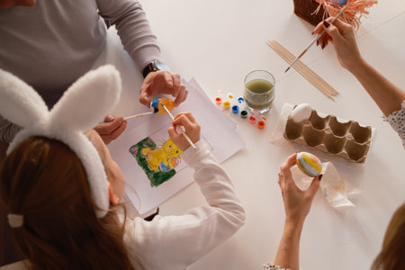 Family decorating Easter eggs in a festive and creative springtime settingの写真素材