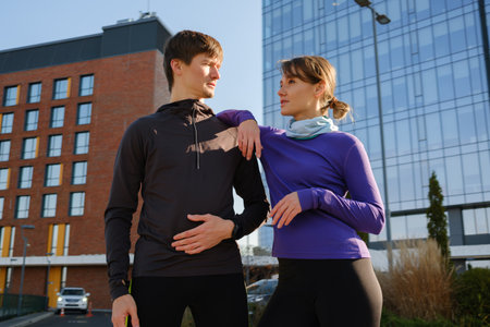 Couple enjoying a jogging session in a citys modern urban environmentの写真素材