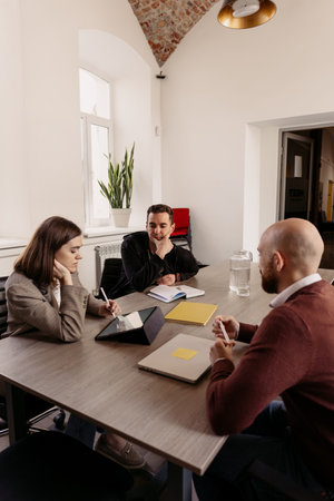 Team members collaborating in a modern office workspace for a project discussion