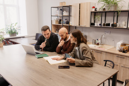 Business professionals discussing documents together during a meeting in an office